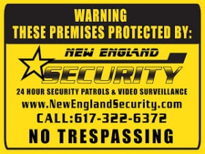 Warning sign indicating "No Trespassing" and detailing security services provided by New England Security, including