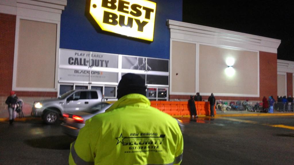 Black Friday crowd management and security at Best Buy, security guard in reflective vest.