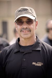 Jerry Gallo in a black polo shirt and cap, representing New England Security, showcasing his